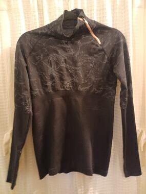 Fabletics Amelie Asymmetrical 1/4 Zip Pullover in a black marbled jacquard patte